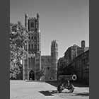 monochrome photo of Ely Cathedral West Tower with cannon in front